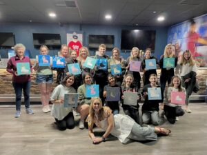 Group holding their finished painting creations